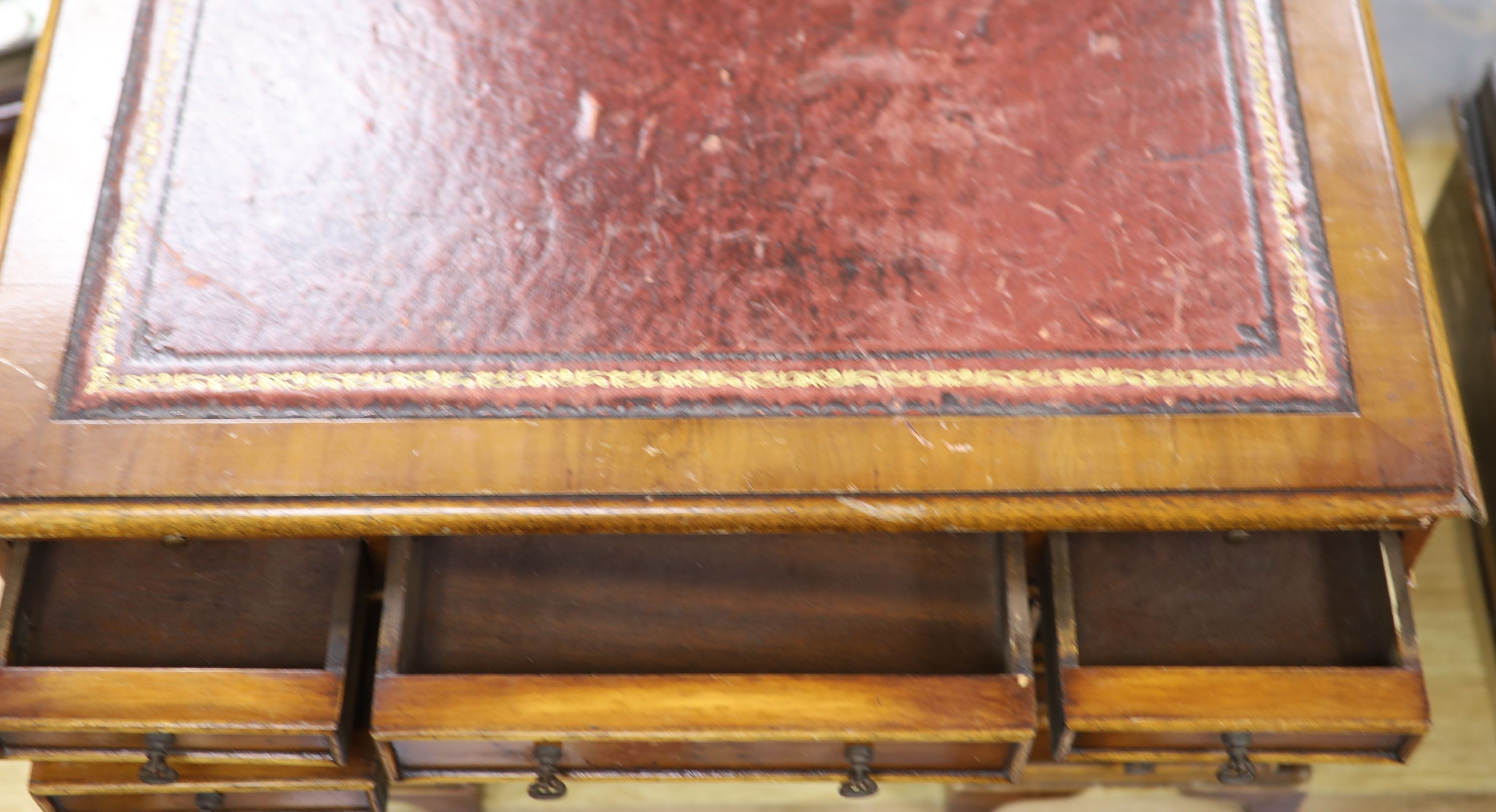 A miniature yew wood table top kneehole desk, length 52cm